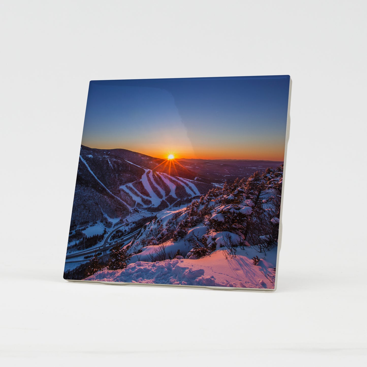 Last Winter Sunset over Cannon Mountain Ceramic Coaster by Chris Whiton